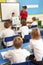 Schoolchildren Studying In Classroom With Teacher