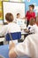 Schoolchildren Studying In Classroom With Teacher