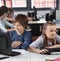 Schoolchildren Using Computer At Desk