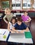 Schoolchildren Using Laptop At Desk In Classroom