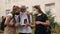 Schoolchildren wearing masks communicate in the school yard