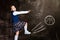 Schoolgirl against chalkboard, kicking a ball