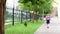 Schoolgirl with backpack, flowers bouquet say goodbye and go away. Girl standing near school with bouquet of flowers and