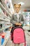 Schoolgirl with backpack in hand, stationery store