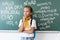 Schoolgirl with backpack looking away on