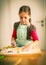 Schoolgirl baking cookies