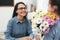 Schoolgirl with bouquet congratulating her pedagogue in classroom, closeup. Teacher`s day