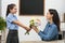 Schoolgirl congratulating her pedagogue with bouquet in classroom. Teacher`s day