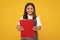 Schoolgirl with copy book posing on isolated background. Literature lesson, grammar school. Intellectual child reader