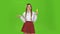 Schoolgirl with a credit card in her hands is sad. Green Screen