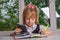 Schoolgirl doing homework on the tablet, free space.