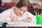 Schoolgirl Drawing At Desk