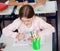 Schoolgirl Drawing At Desk In Classroom