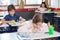 Schoolgirl Drawing While Leaning On Desk In