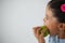 Schoolgirl eating apple against white background