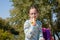 Schoolgirl eating a banana in the street. Alpha generation children will be the driving force behind progress