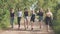 Schoolgirl friends are walking outside the city along a forest road.