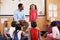 Schoolgirl at the front of elementary class with teacher