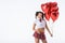 schoolgirl with helium balloons in shape of hearts