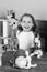 Schoolgirl at her desk with yellow flowers, globe and microscope