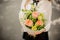 Schoolgirl holding a little bouquet of flowers