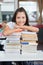 Schoolgirl Leaning On Stacked Books At Desk