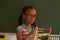 Schoolgirl learning mathematics with abacus in the classroom