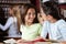 Schoolgirl Looking At Female Friend In Library