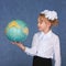 Schoolgirl looking at a geographical globe