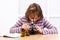 Schoolgirl looking into microscope