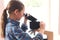 Schoolgirl looking in microscope on lesson