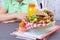 Schoolgirl and lunch with juice, books for study on the table near the board. Free space for text. Healthy food for the baby.