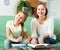 Schoolgirl and mother doing homework