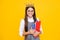 Schoolgirl nerd princess in school uniform and crown celebrating victory on yellow background. School child hold book