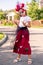 Schoolgirl with painted face in halloween costume looking with sulky expression