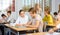 Schoolgirl peeks in a boys notebook during classes in school class