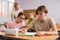 Schoolgirl peeks in a boys notebook during classes in school class