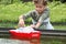 Schoolgirl with plastic boat