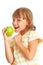 Schoolgirl portrait eating green apple isolated