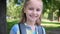 Schoolgirl posing on sunny park background