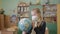 A schoolgirl in a protective mask during a pandemic holds a globe in her hands.