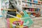 Schoolgirl puts a notebook in the cart, stationery