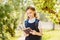 Schoolgirl reads book outdoors