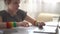 Schoolgirl records a lecture and completes a task in a notebook. Close portrait of a curly-haired girl has online