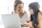 Schoolgirl researching online with the guidance of her teacher