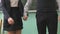 Schoolgirl and schoolboy take each other hands