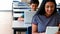 Schoolgirl and schoolboy using laptop and digital tablet while studying in classroom