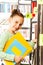 Schoolgirl searches books and holds exercise book