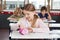 Schoolgirl Searching In Pouch At Desk