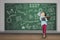 Schoolgirl shouting with megaphone in classroom